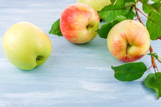 white apples with red side on blue background