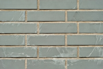 Texture of brick wall. new brickwork. Samples of wall or fence are presented at exhibitions. Gray brick close up.