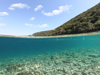 Fototapeta premium Sea level and underwater photo of beautiful pebble beach of Krovoulia near picturesque village of Frikes, Ithaki island, Ionian, Greece