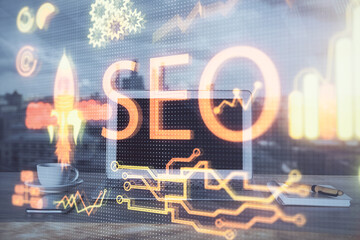 Multi exposure of table with computer and seo drawing hologram. Search optimization concept.