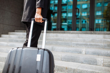 Close up of a young business woman walking up the staircase with a suit ready to check in at...