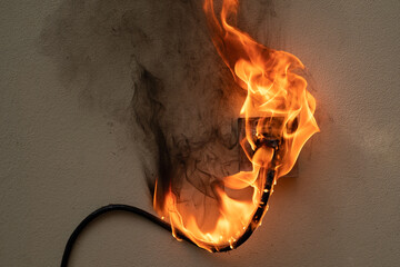 On fire electric wire plug Receptacle on the concrete wall exposed concrete background with copy...