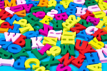 Different letters of the English alphabet. Bright Latin letters in a chaotic arrangement. Concept - learning English letters. The alphabet as a symbol of primary education. Primary school education