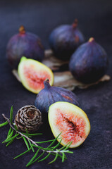 Fresh ripe purple figs on the table. Black background. Top view. Flat lay. Healthy food concept.  Organic. 