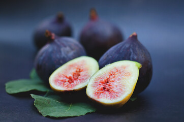  Fresh ripe purple figs on the table. Black background. Top view. Flat lay. Healthy food concept.  Organic. 