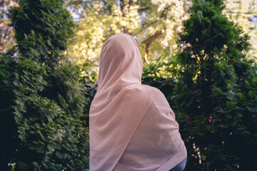 Autumn. Lonely muslim woman in a headscarf  walking in a park, garden. Vintage Toned