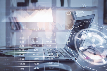 Stock market graph on background with desk and personal computer. Multi exposure. Concept of financial analysis.