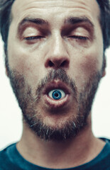 Obraz premium Portrait Of A Man With An Eye In His Mouth
