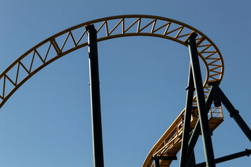 The metal structure is part of the roller coaster ride.
