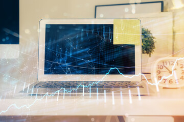 Forex market chart hologram and personal computer background. Double exposure. Concept of investment.