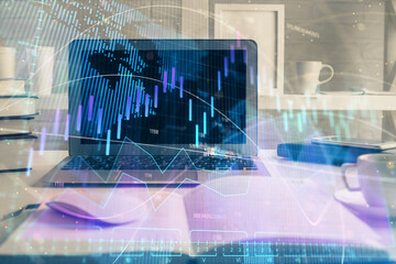 Forex market chart hologram and personal computer background. Double exposure. Concept of investment.