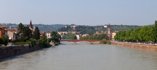 A panoramic cityscape view of Verona old town and the bridge over the Adige river.