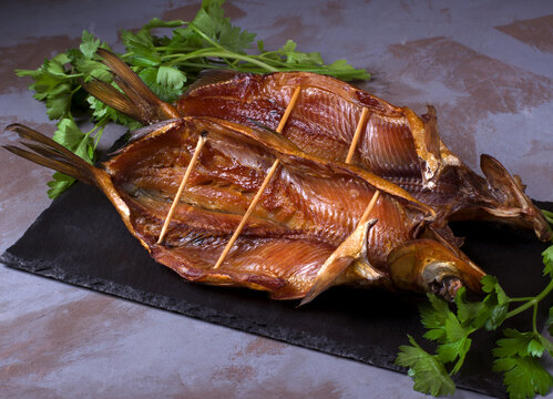 Smoked omul fish on the stone board