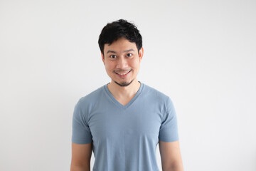 Portrait of happy Asian man in blue t-shirt on isolated white background.