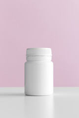 White pill bottle mockup with pink background.
