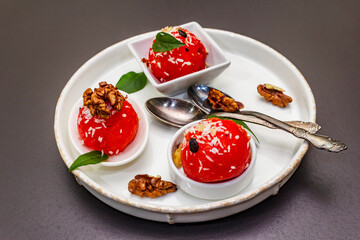 Watermelon ice cream or sorbet with coconut flakes, walnuts and fresh basil leaves