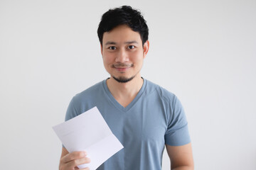 Happy Asian man is holding an invoice letter on isolated white background.