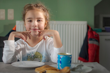 little child eating breakfast