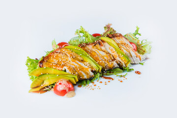 Side view of Pan Asian Eel salad with avocado, salad mix, cherry tomatoes served with sesame seeds isolated on white background. Japanese seafood dish isolated. Restaurant menu fish salad