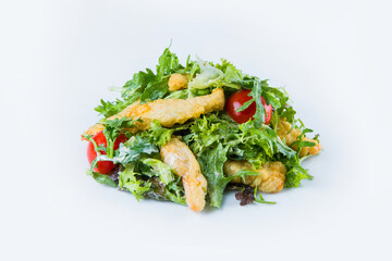Tempura chicken with salad mix and cherry tomatoes isolated on white background. Side view of fresh...