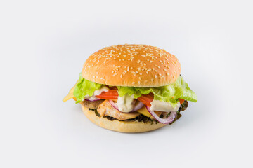 Chicken burger with vegetables and cheese in wheat bun with sesame seeds. Meat Burger with fresh salad leaves, tomatoes, Spanish onions isolated on white background. Food Isolation restaurant menu