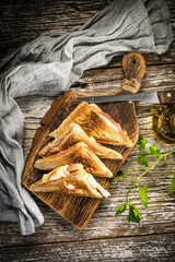 Grilled cheese sandwich on cutting board.