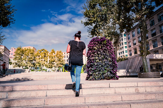 A Nice Woman Is Walking In Town With Jeans And Taking The Stairs