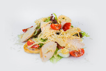 Traditional Caesar salad with chicken fillet slices, quail eggs, cherry tomatoes and salad mix isolated on background. European Restaurant menu dish served With Parmesan cheese on gray background