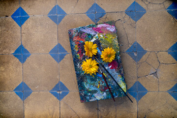 Palette with Painting Material and a Bouquet of Summer Flowers and sunflower.
