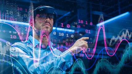 Caucasian Male IT Specialist and Businessman Wearing Futuristic VR Helmet and Working with Digital Data. Concept Shot of High Speed Internet Visualization and Graph Statistics in Foreground