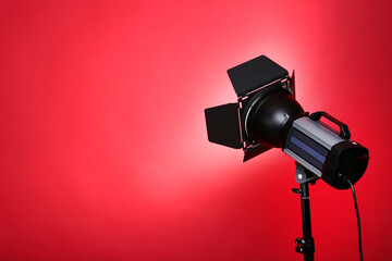 Studio lighting with tripod on red background