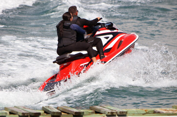 Couple ring tandem on a speeding jetski