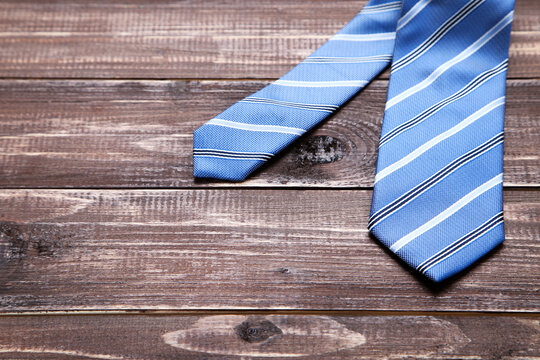 Striped necktie on brown wooden table