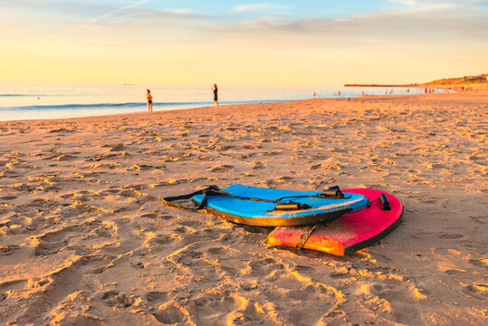 Swimming bodyboards on the sand at sunset, Christies Beach, South Australia