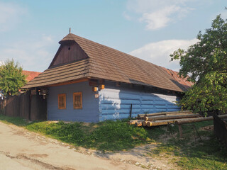 Fototapeta na wymiar VLKOLINEC, SLOVAKIA, EUROPE, SUMMER 2015. Beautiful country house with traditional Slovak blue painted wooden architecture in the Unesco Heritage village of Vlkolinec.