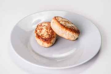 Close up of Two chicken Meatballs served on gray plate. Russian traditional Homemade meat cutlets isolated on gray background. Slavic food menu
