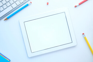 top view of digital tablet with office suppliers on table 