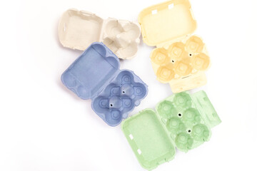 Green, yellow, blue paper egg box, case, holder, package, top view on white background, abstract colors combination