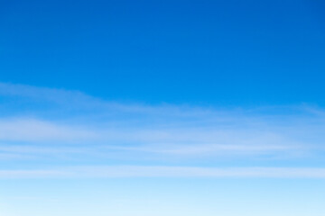 Clear blue sky with white cloud background