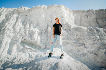Fasion model girl posing on the background of the white mountain