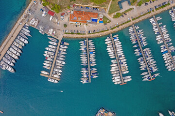 Top view on Vrsar harbour with plenty of ships during daytime with turquoise water