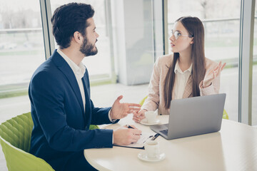 Portrait of his he her she two nice attractive stylish experienced qualified skilled people meeting discussing sales management innovation progress drinking espresso light white workplace workstation