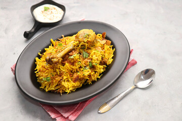 Chicken Biryani/murg Pulao.  Garnished with fried onion & chopped coriander. Biryani raita is a famous Spicy non vegetarian dish of India. Chicken cooked along with Basmati rice & spices. copy space.