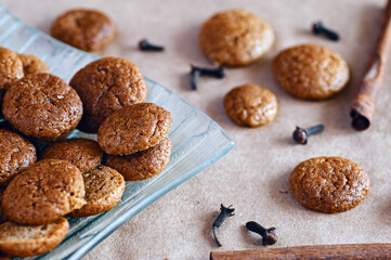 Baked spicy ginger bread sweet cookies with cloves and cinnamon sticks