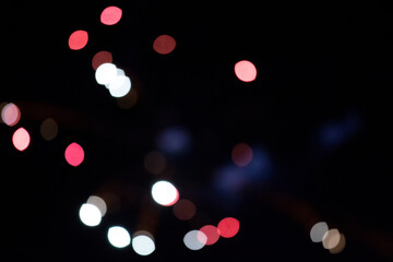 Multicolored bokeh spots on a black background.