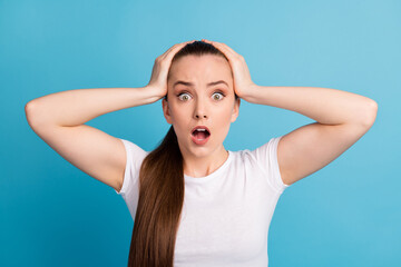 Portrait of astonished panic nervous girl hear horrible news impressed touch hands head wear good look clothes isolated over blue color background