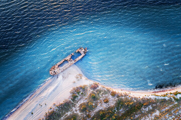 Old shipwreck reinforced concrete barge abandoned stand on beach on the coast of Black sea in...