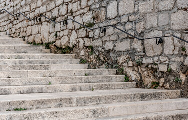 Old sandstone staircase along the stone wall in Sibenik, Croatia