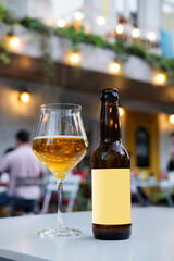 A bottle of golden ale on the table