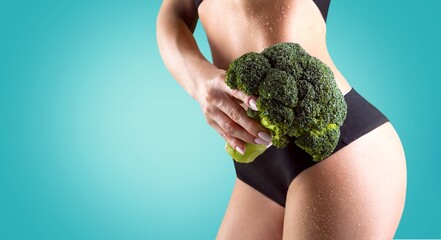 Slim young woman showing healthy vegetable